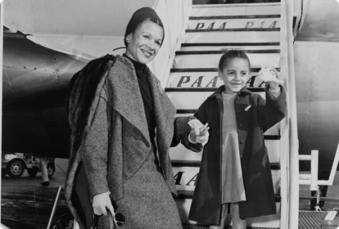 Katherine Dunham and her daughter Marie Christine board an airplane in New York bound for Rome, 1953